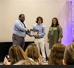 Ktech student receiving certificate on stage